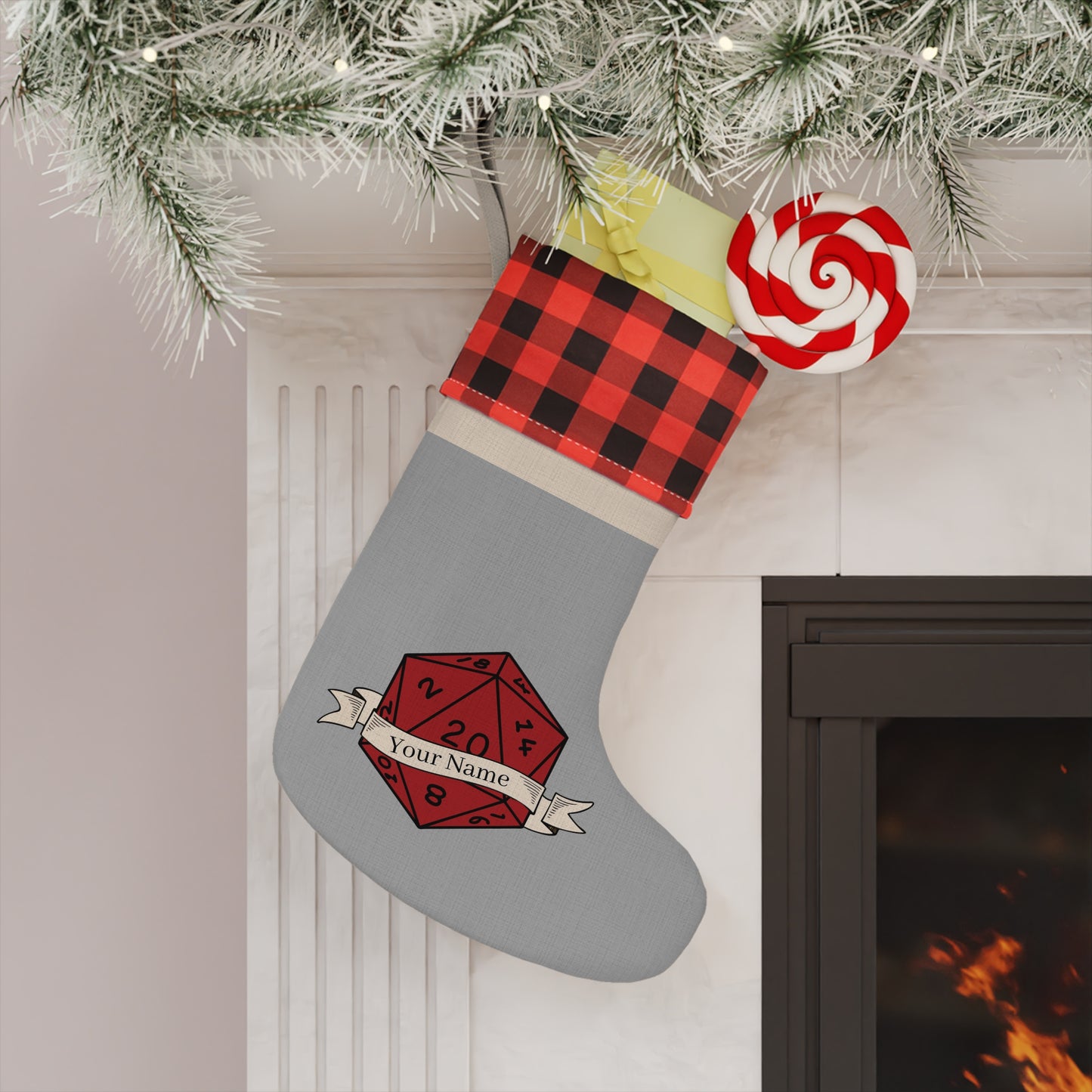 A personalized D20 Christmas stocking hanging from a fireplace, with a buffalo plaid design, a red and white candy cane, and customizable text on the front.