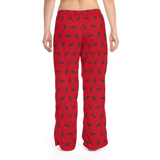 Red pajama pants with black and green pattern on a white background