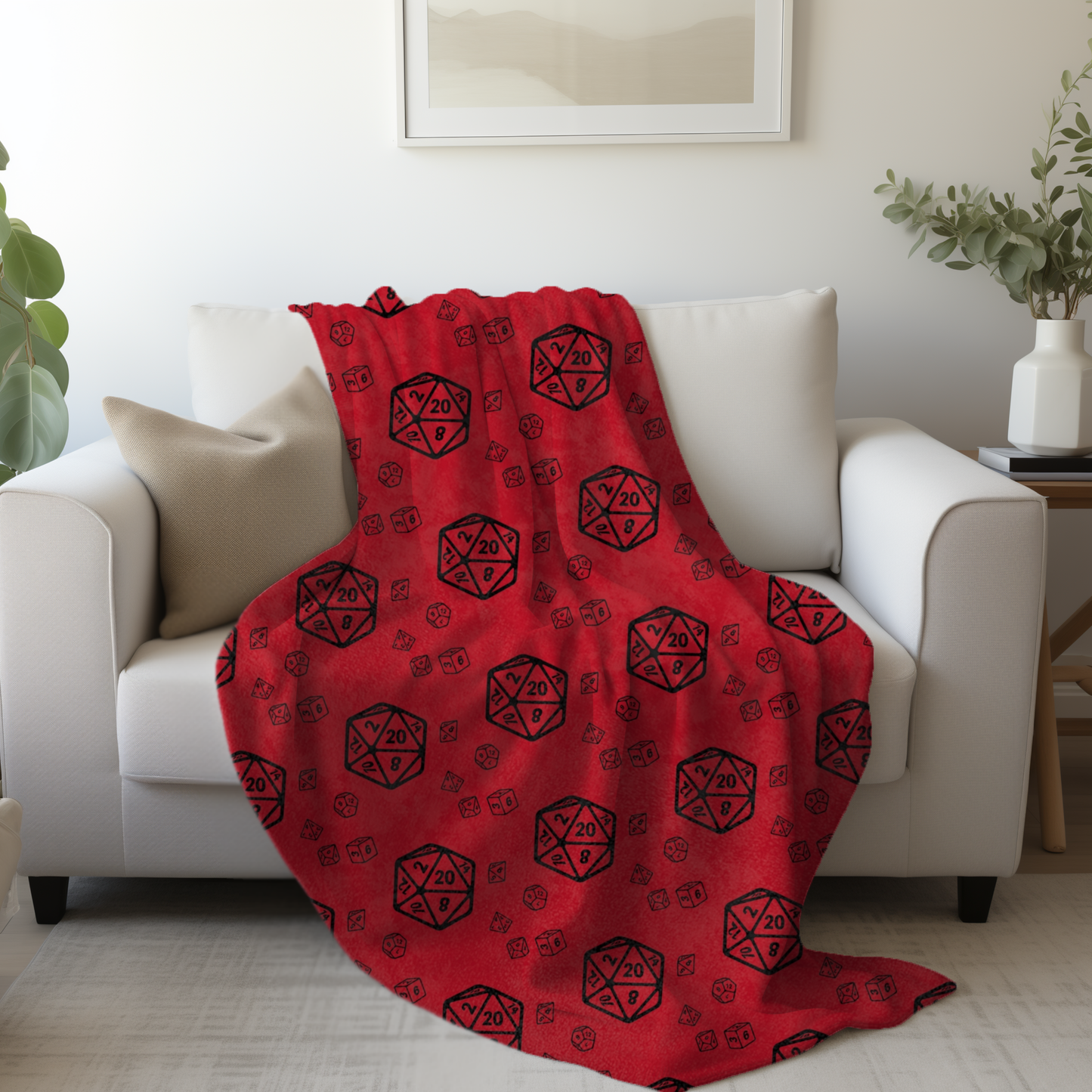 Red blanket with black dice patterns draped over a white couch in a living room.