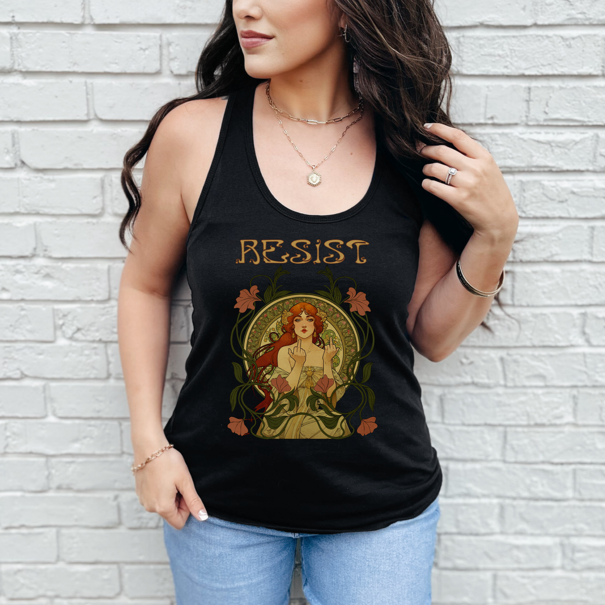 Woman wearing a black tank top with 'RESIST' graphic design against a white brick wall.