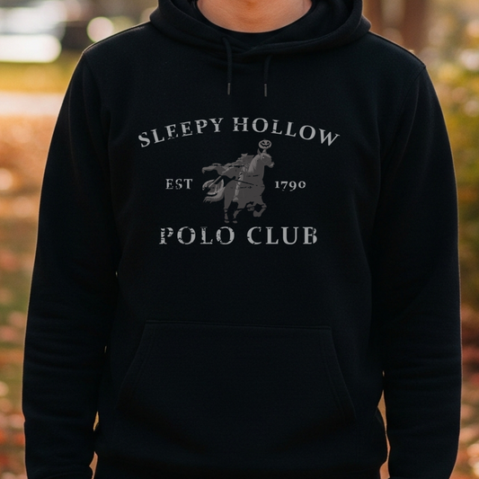 Person wearing a black hoodie with 'Sleepy Hollow Polo Club' text and logo in an autumn setting.