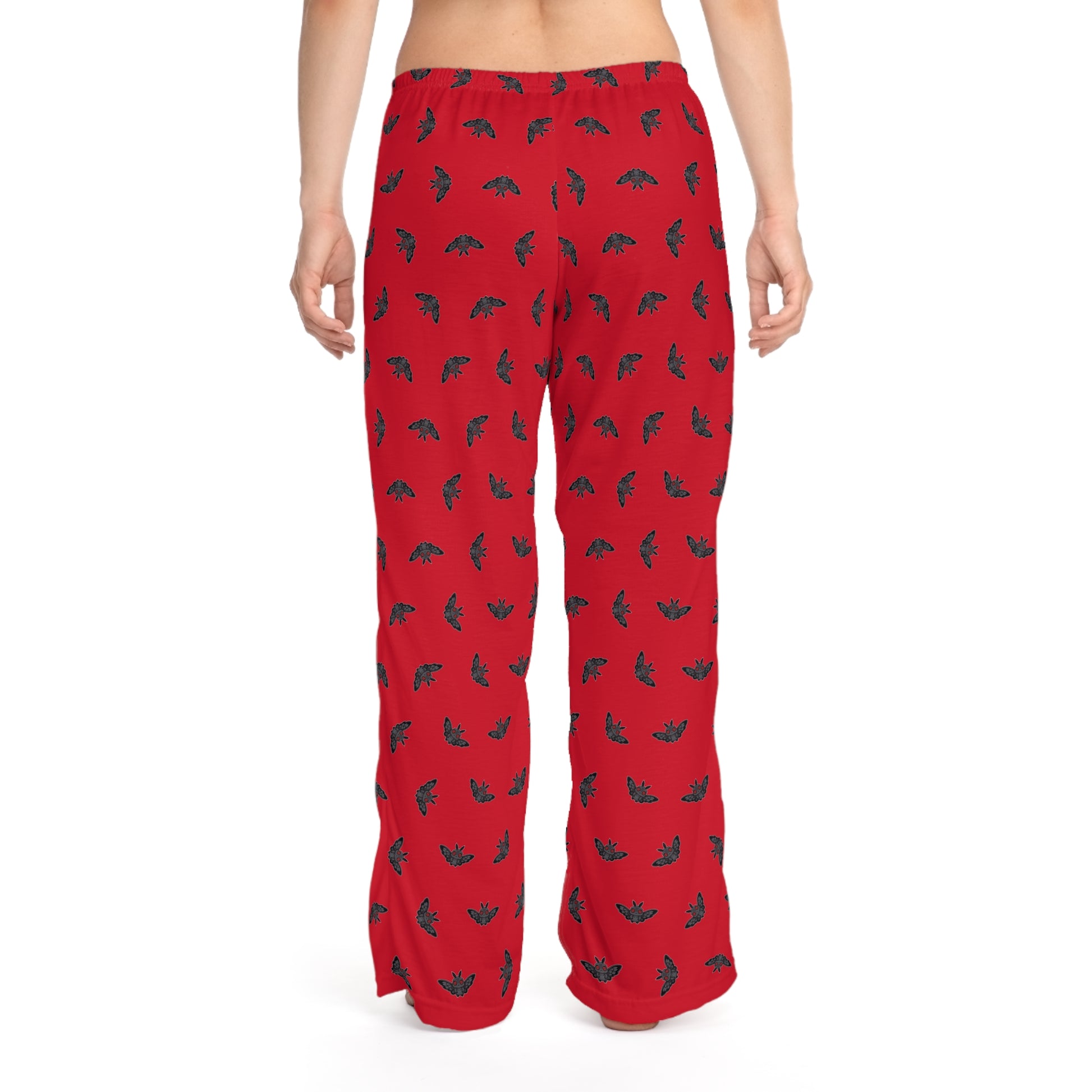 Red pajama pants with black and green pattern on a white background